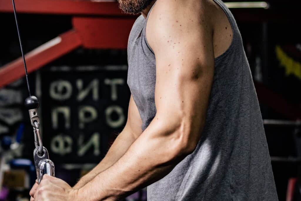 Image of a man doing triceps pushdowns on a cable. Pexels